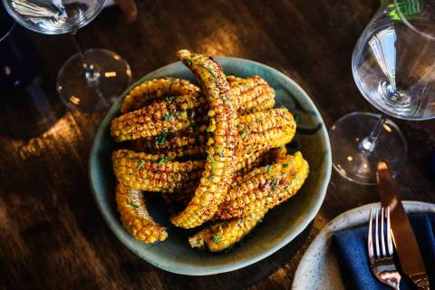 Sweet corn ribs, covered in miso honey butter, chives and Aleppo chile, at Ada’s Wine Bar in ...