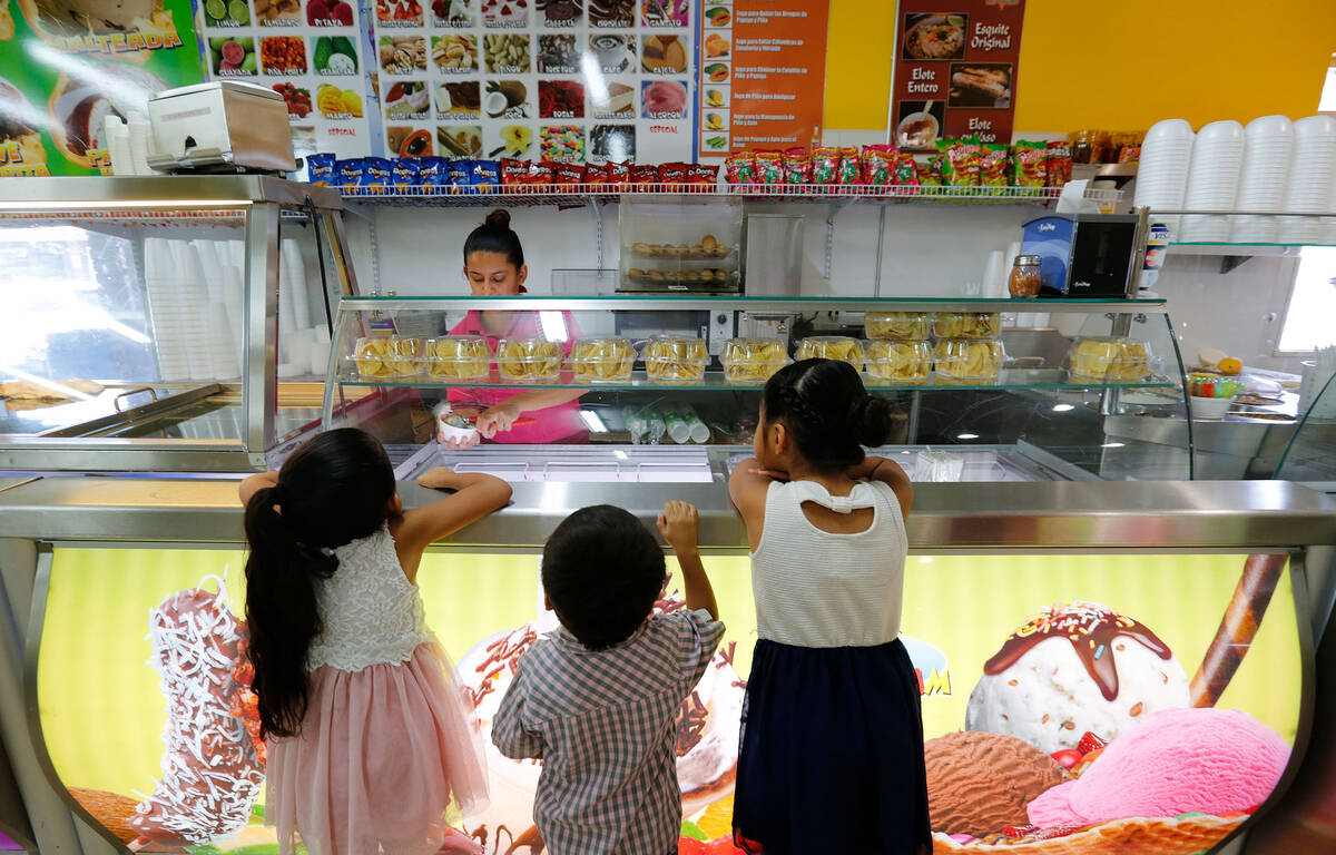 Angelina Gonzalez, 6, from left, her brother Julius, 3, and her sister Vianna, 7, watch their m ...