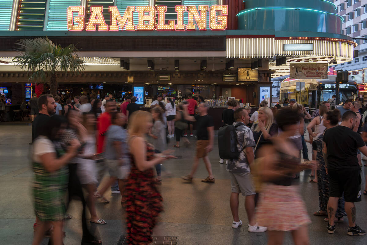 People walk through the Fremont Street Experience on Tuesday, July 5, 2022. City leaders are co ...