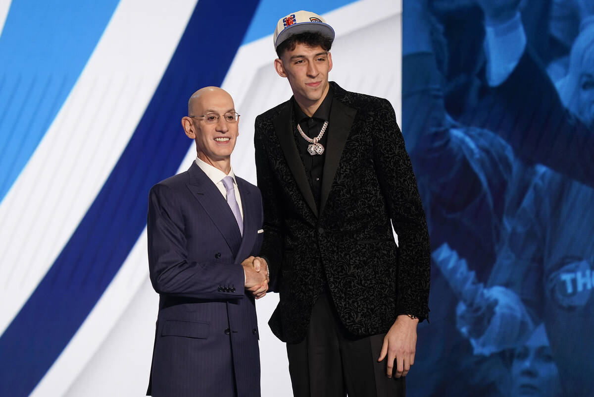 Chet Holmgren, right, poses for photos with NBA Commissioner Adam Silver after being selected s ...