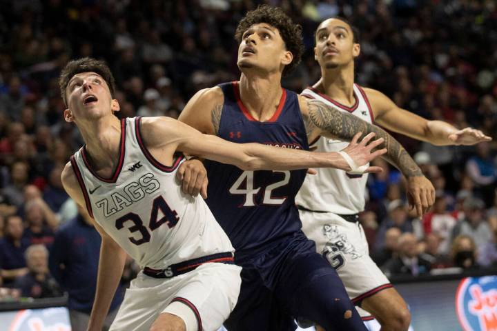 Gonzaga Bulldogs center Chet Holmgren (34) boxes out St. Mary's Gaels forward Dan Fotu (42) in ...