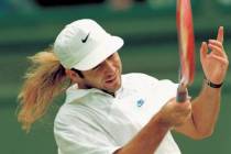 Andre Agassi swings into a return to Goran Ivanisevic, during the men's singles final on the Ce ...