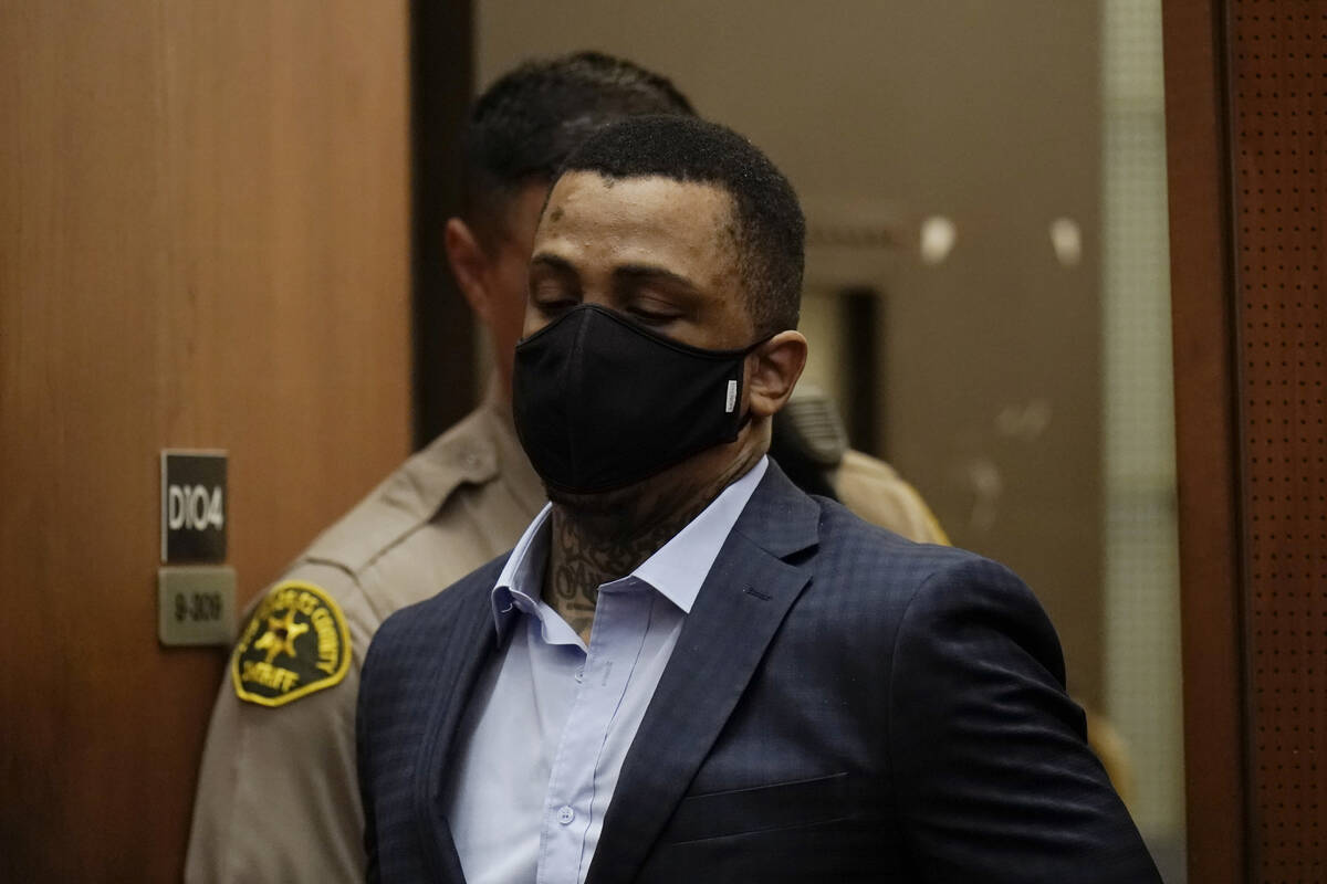 Eric Holder Jr., who is accused of killing rapper Nipsey Hussle, enters a courtroom to hear the ...