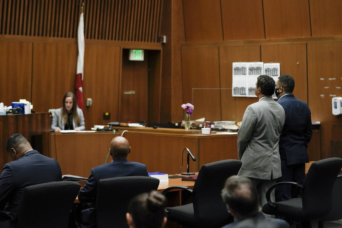 Eric Holder Jr., right, who is accused of killing rapper Nipsey Hussle, and his attorney, Aaron ...