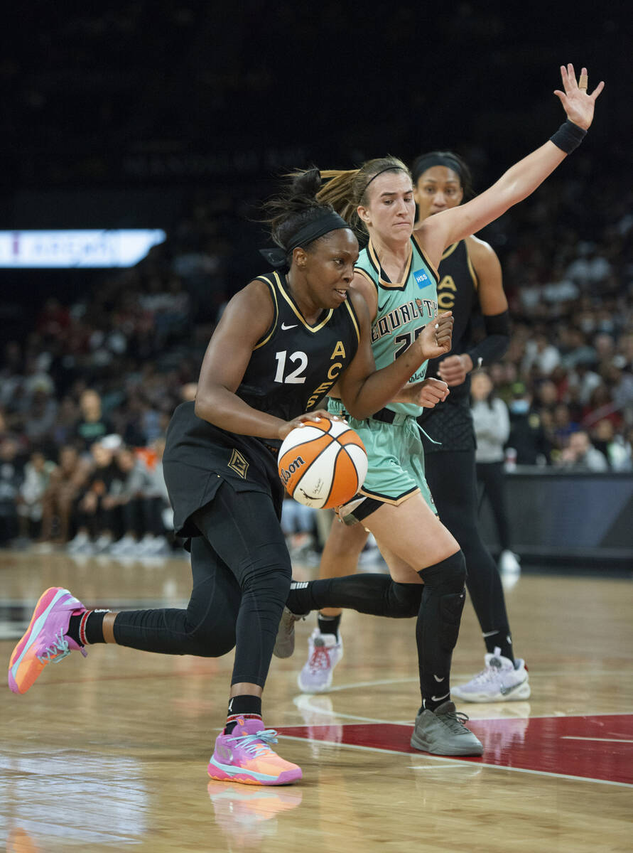 Las Vegas Aces guard Chelsea Gray (12) gets past New York Liberty's Sabrina Ionescu (20) during ...