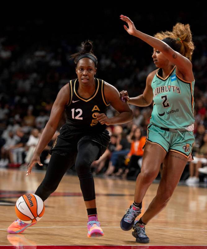 Las Vegas Aces guard Chelsea Gray (12) drives past New York Liberty's DiDi Richards (2) during ...