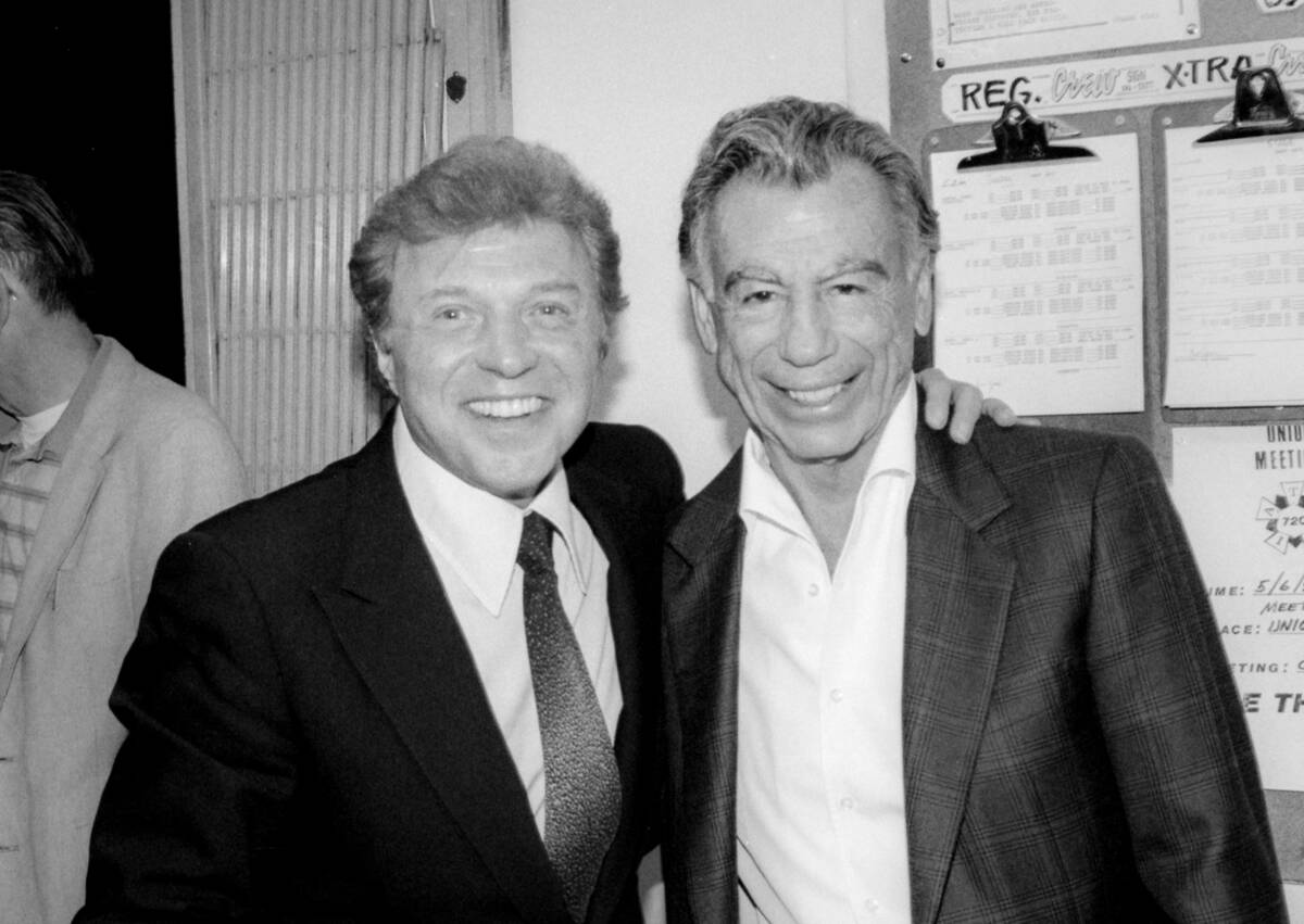 Singer Steve Lawrence, left, with Kirk Kerkorian celebrating Shecky Greene's opening backstage ...