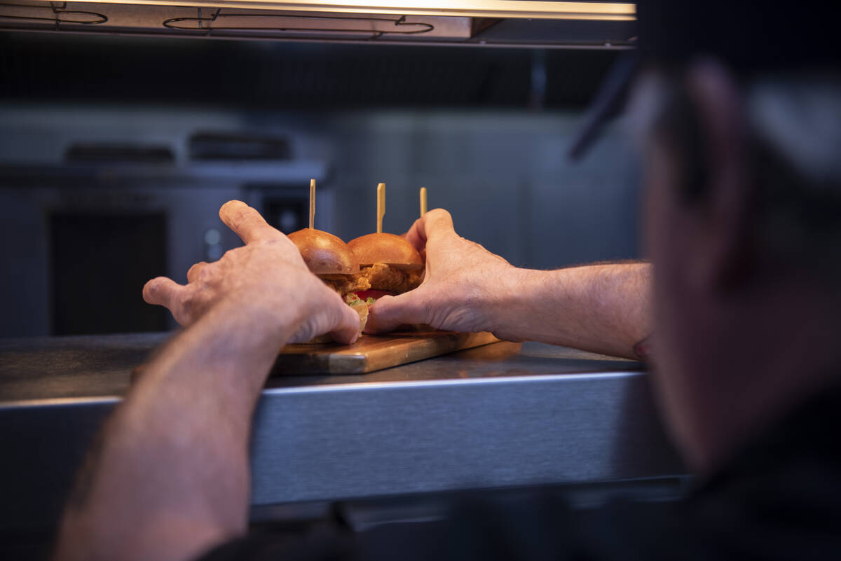 Chef Dermot Driscoll of Brooklyn Bowl prepares a tray of fried chicken sliders on Friday, July ...