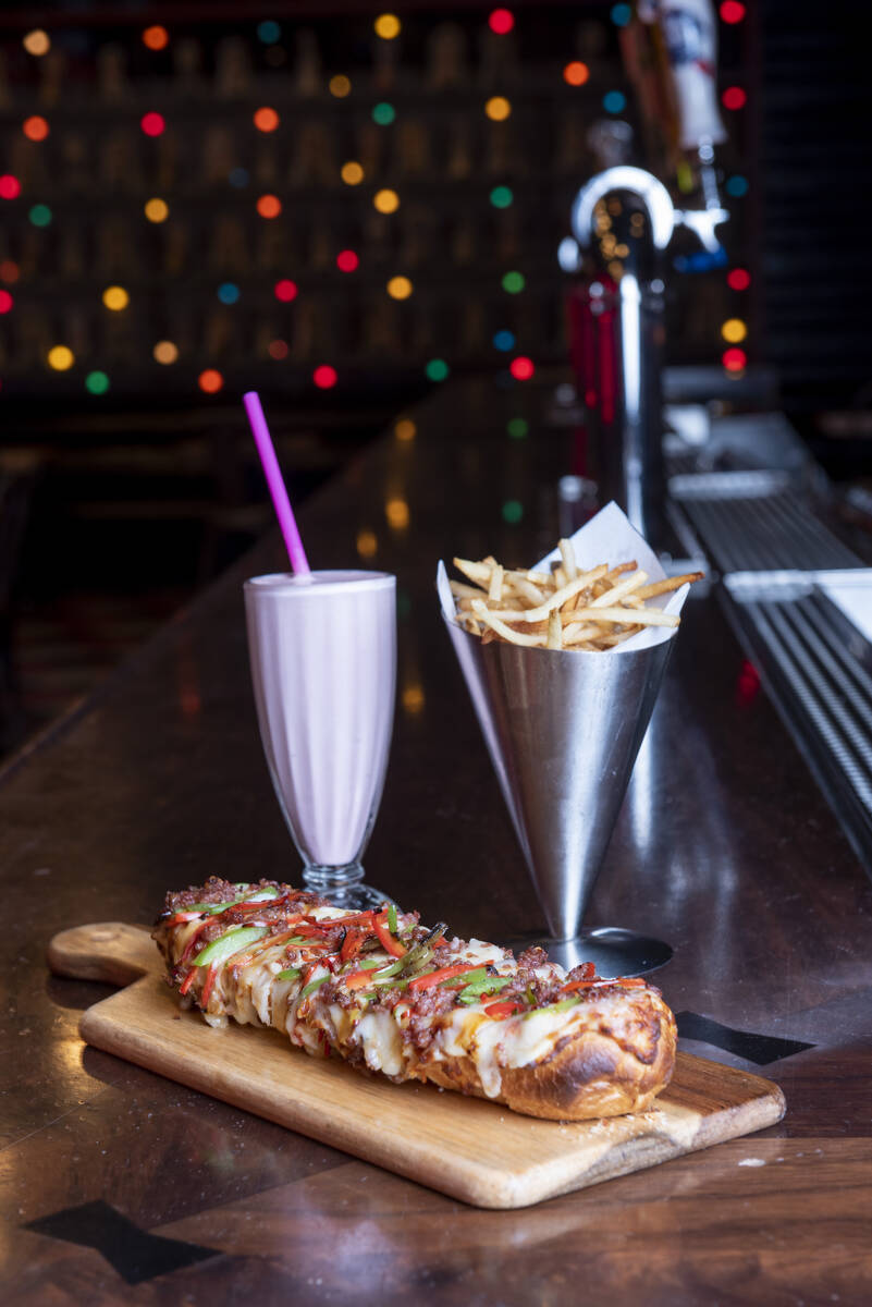 The San Gennaro pizza with a strawberry milkshake and french fries at Brooklyn Bowl on Friday, ...