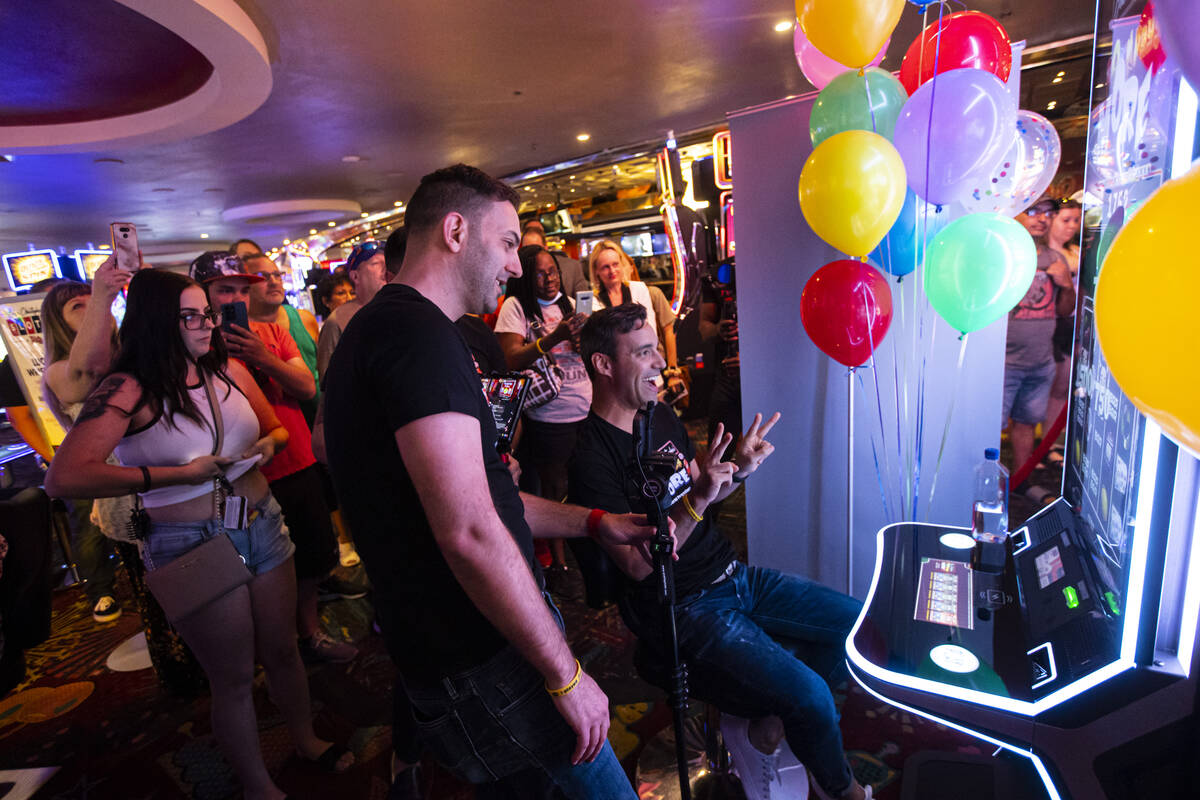 YouTuber Brian Christopher, left, livestreams as his husband, Marco, plays on the new slot mach ...