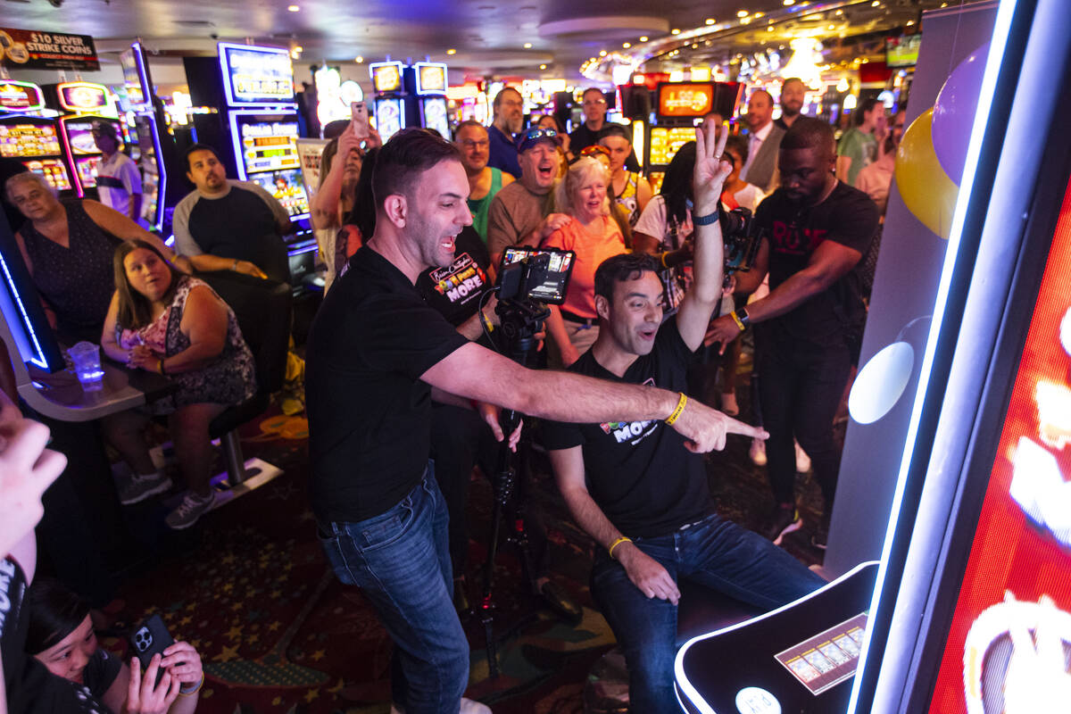 YouTuber Brian Christopher, left, livestreams as his husband, Marco, plays on the new slot mach ...