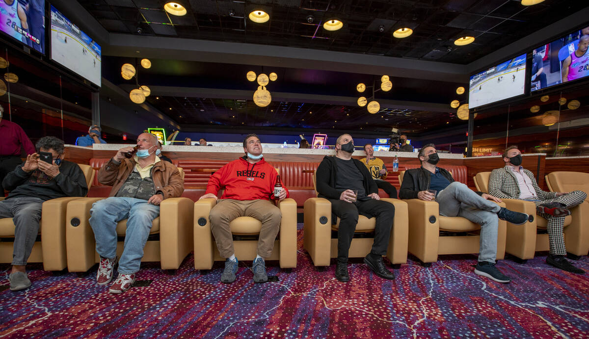 Attendees relax in the leather chairs and watch a few games within the Betfred Sports sports bo ...