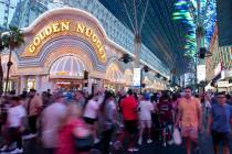 People walk through the Fremont Street Experience on Tuesday, July 5, 2022. City leaders are co ...