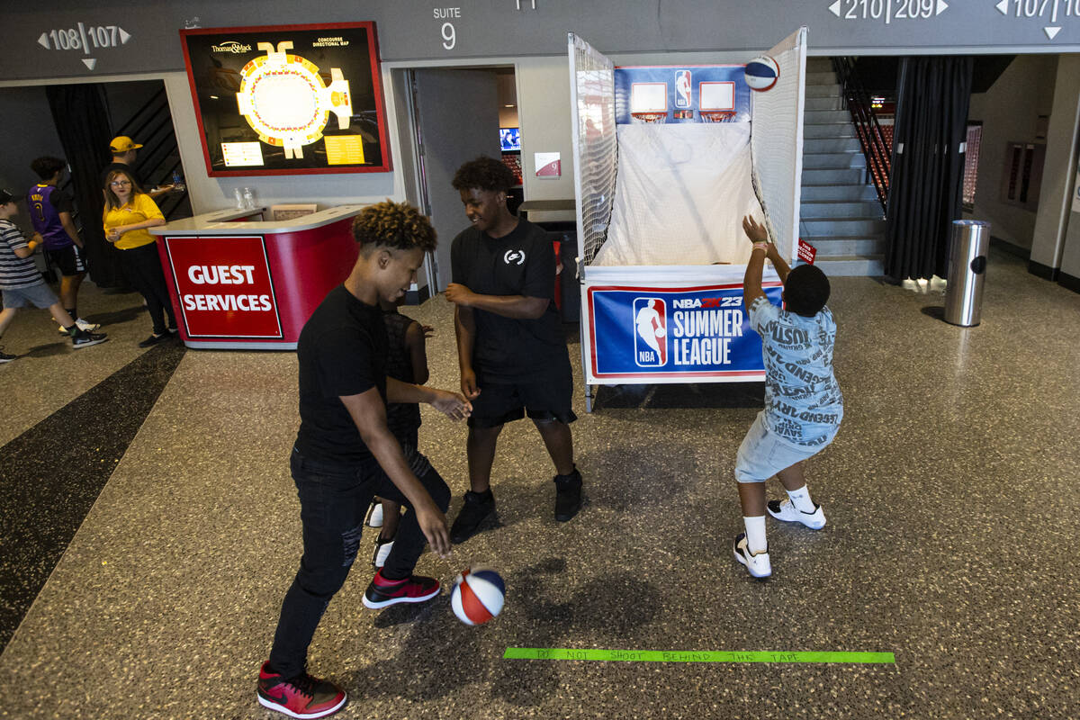 Attendees shoot hoops before the first game of the NBA Summer League on Thursday, July 7, 2022, ...