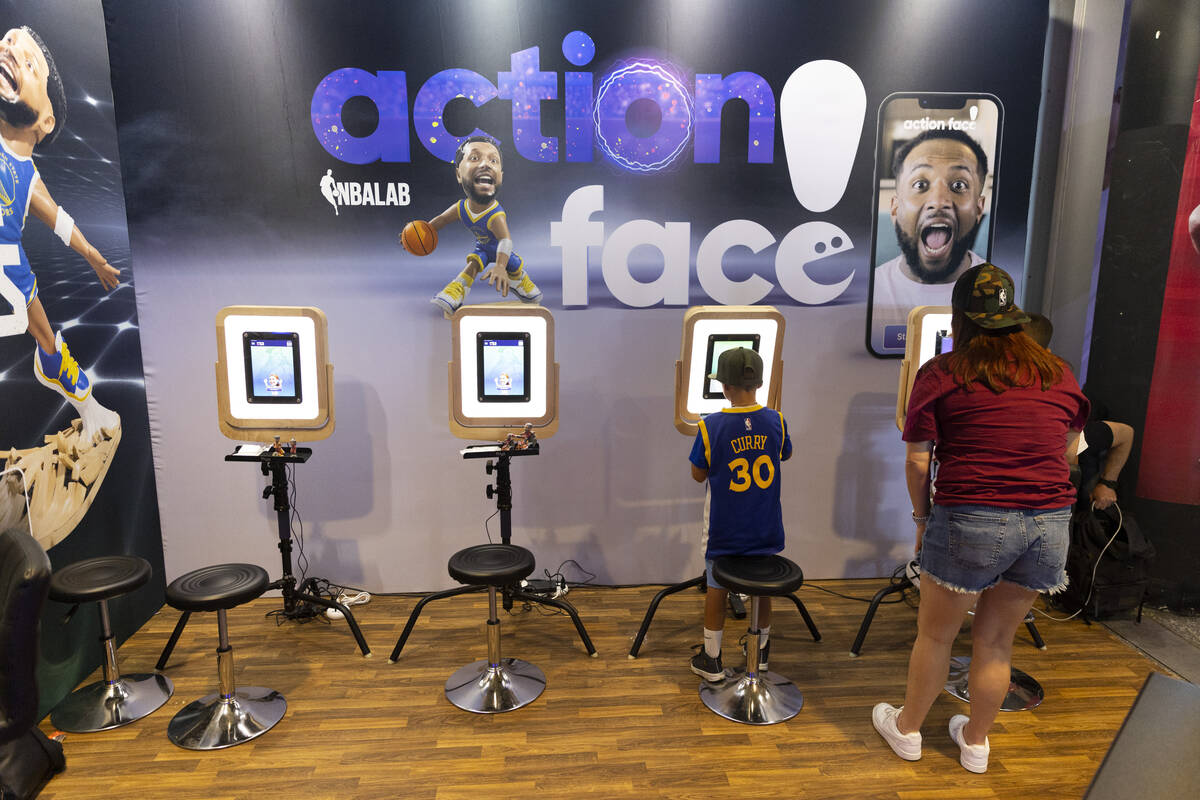 People customize basketball figures at the Action Face booth during the NBA Summer League event ...