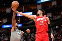 Houston Rockets center Christian Wood (35) and Brooklyn Nets forward Paul Millsap go for a rebo ...