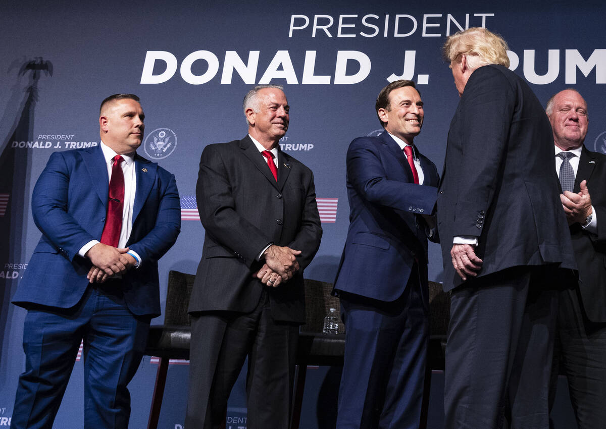 Former President Donald Trump, right, shakes hand with former Nevada Attorney General Adam Laxa ...