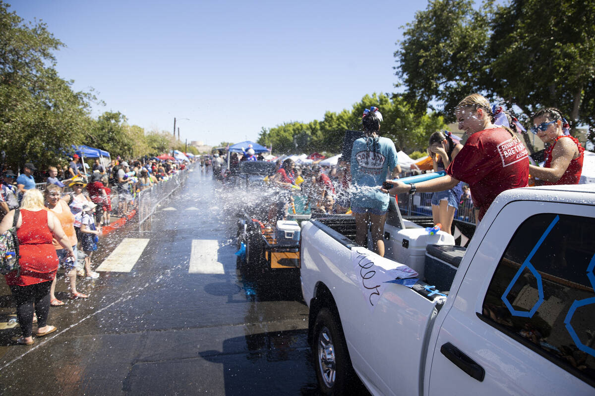 People spray water following the Boulder City's 74th annual 4th of July Parade in Boulder City, ...