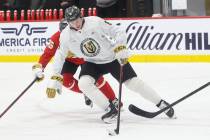 Golden Knights defenseman Kaedan Korczak (6) skates with the puck under pressure from forward C ...