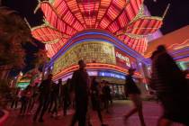 FILE - Tourists walk near the Flamingo casino-hotel on the Strip on Friday, Nov. 27, 2020, in L ...