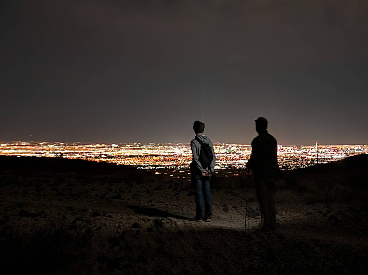 Night hikers enjoy a view of the bright Las Vegas lights from a path connected with the Shadow ...