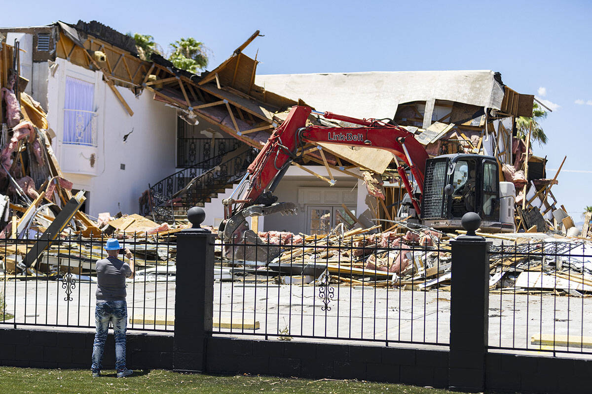 Brian Taco Alvarez takes a photo of the torn down Hartland Mansion on South 6th Street in Downt ...