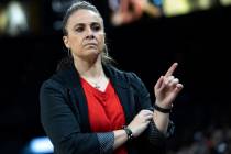 Las Vegas Aces head coach Becky Hammon chooses a player from the bench during the second half o ...