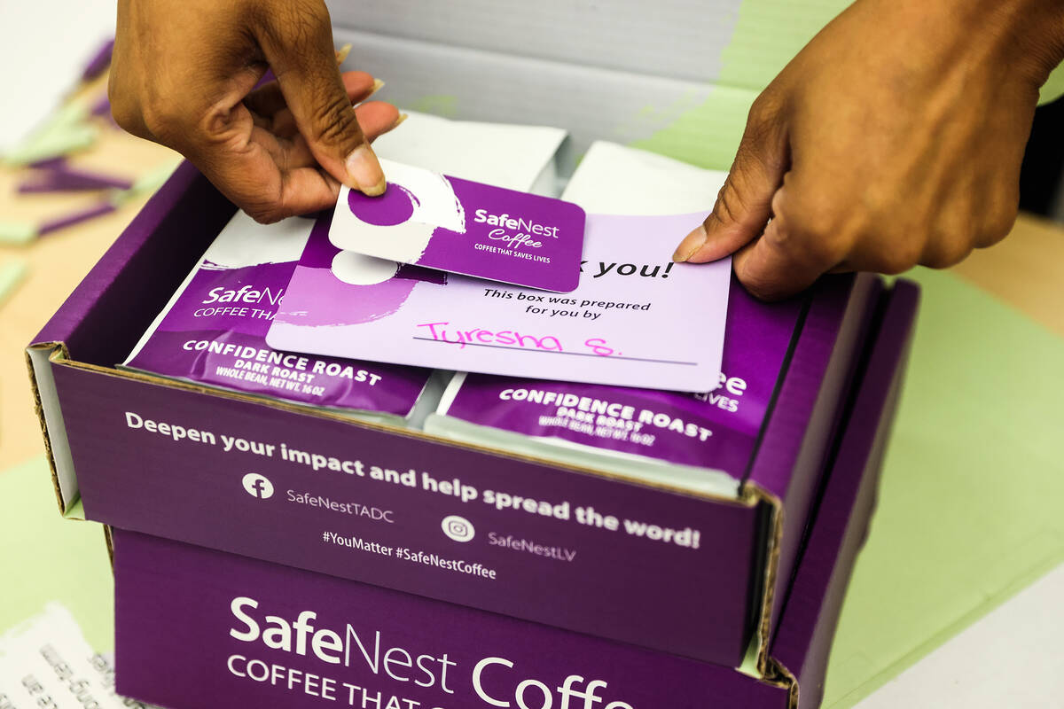 Charmaine packs a box of coffee at SafeNest in Las Vegas, Thursday, July 14, 2022. Charmaine an ...