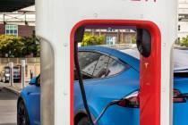 A car is plugged in at the Tesla Supercharger station near The LINQ and High Roller on Friday, ...