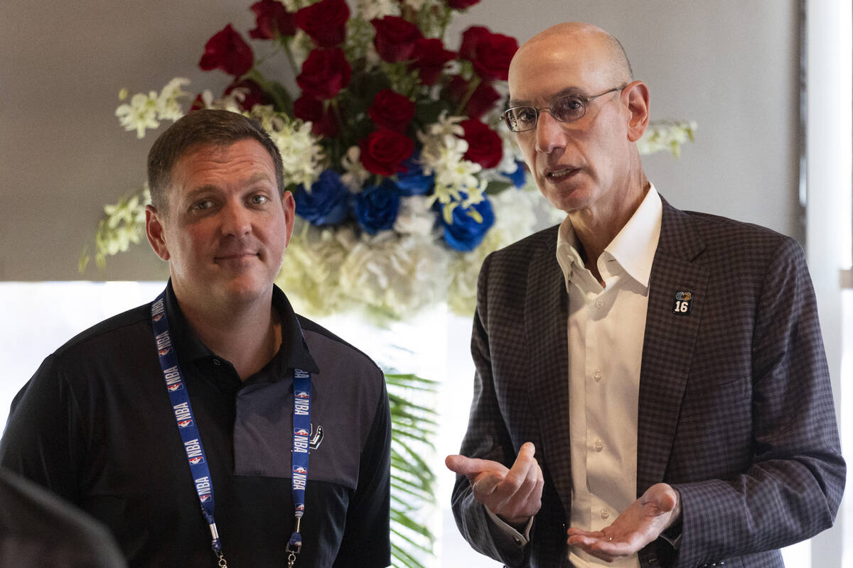 Peter J. Holt, left, chairman of Spurs Sports & Entertainment, speaks with NBA commissioner ...