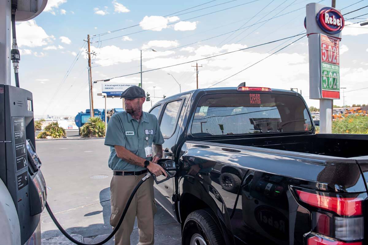 Albert Diaz pumps his gas at a Rebel station on North Rancho Drive on Tuesday, July 12, 2022, i ...
