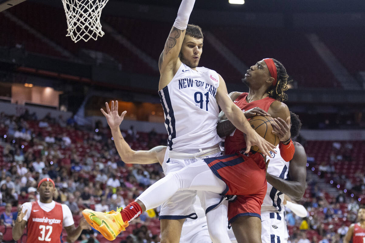 Washington Wizards' Tahjere McCall (8) attempts a shot under pressure from New Orleans Pelicans ...