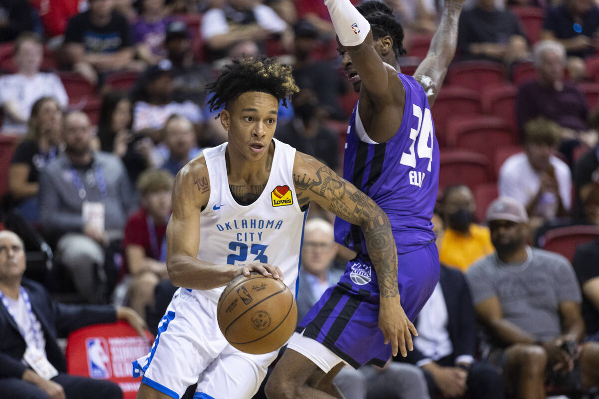 Oklahoma City Thunder's Tre Mann (23) dribbles the ball past Sacramento Kings Keon Ellis (34) d ...