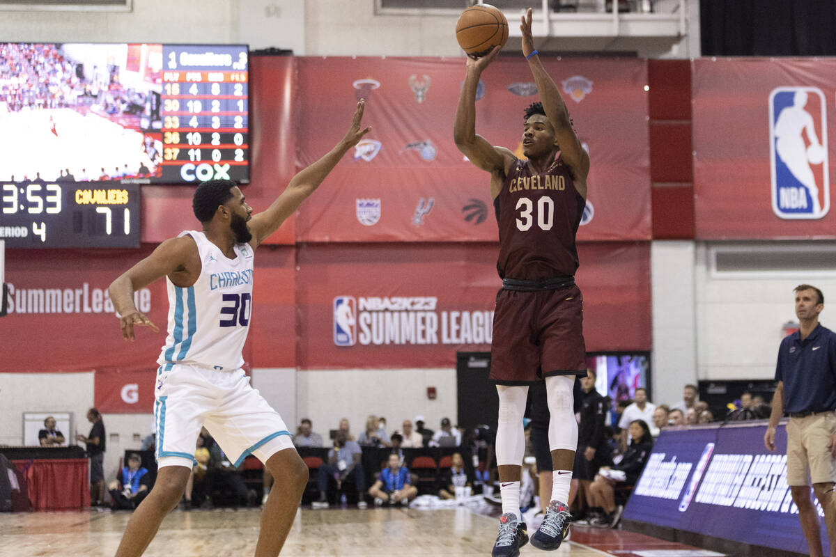 Cleveland Cavaliers Ochai Agbaji (30) takes a shot under pressure from Charlotte Hornets LJ Fig ...