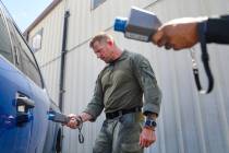 Luke Nelson, a North Las Vegas SWAT officer, surveys a vehicle to identify suspected radioactiv ...