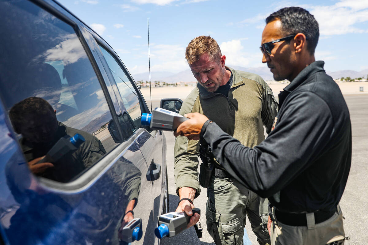 Luke Nelson, a North Las Vegas SWAT officer, left, works alongside Robert Schumann, a North Las ...