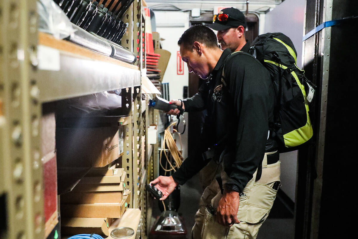 Robert Schumann, a North Las Vegas police officer, left, works with Everett Bates, a Las Vegas ...