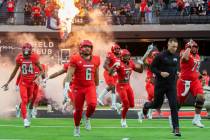 UNLV Rebels head coach Marcus Arroyo leads his team onto the field before the start of an NCAA ...