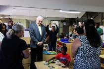 Gov. Steve Sisolak hangs out with Robert Lamoth-Nix, 5, at the College of Southern Nevada&#x201 ...