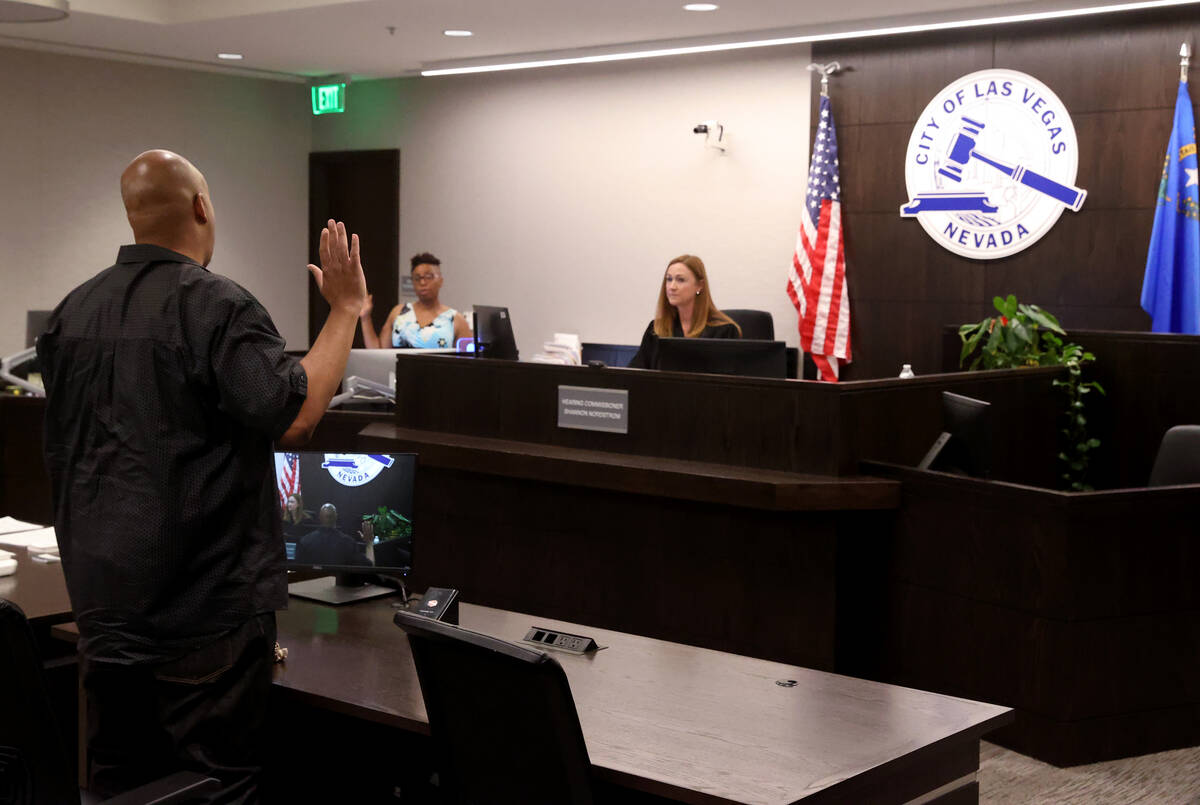 Robert Laws, who was ticketed for running a stop sign, is sworn in before testifying during his ...