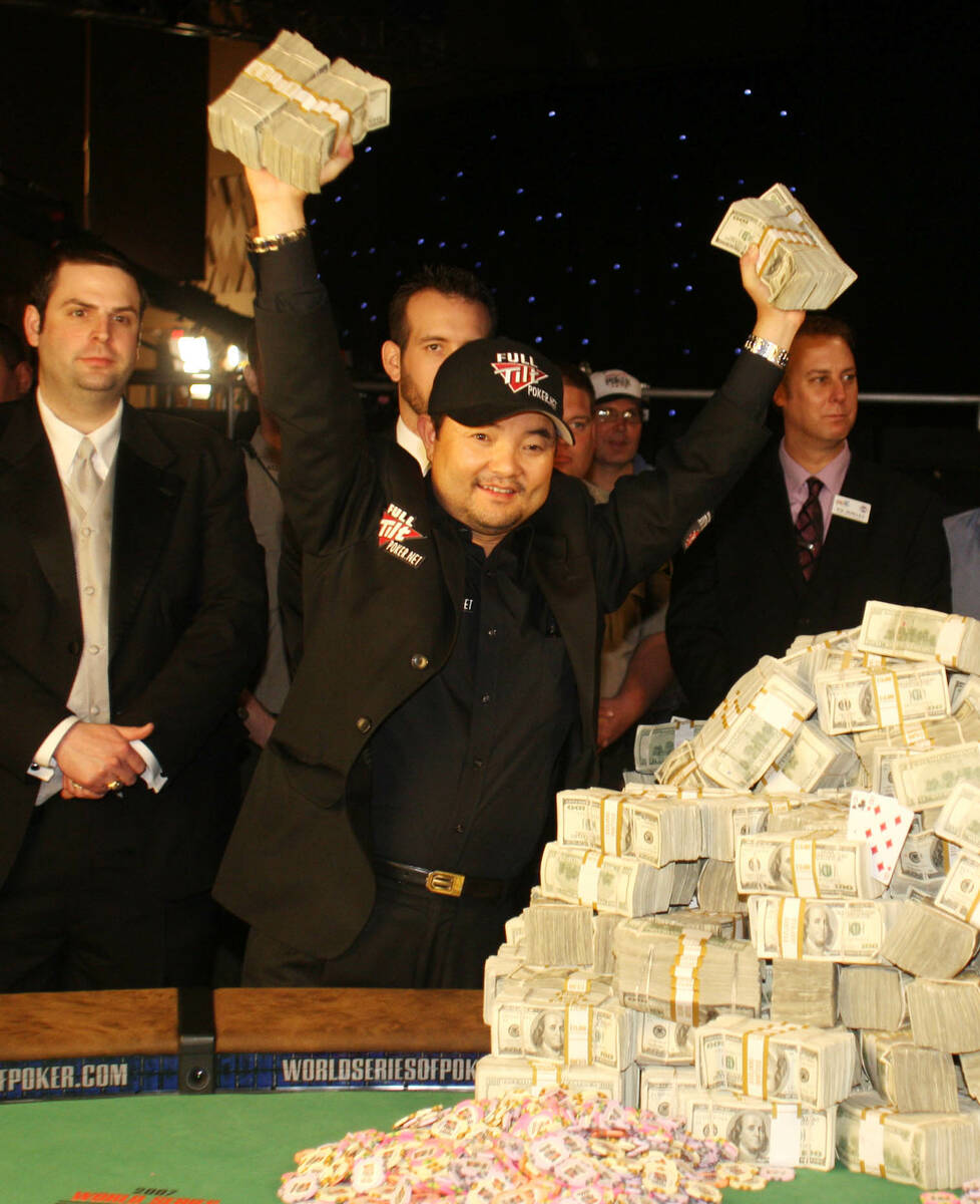 Jerry Yang of Temecula, Calif., holds part of his $8.25 million prize above his head after winn ...