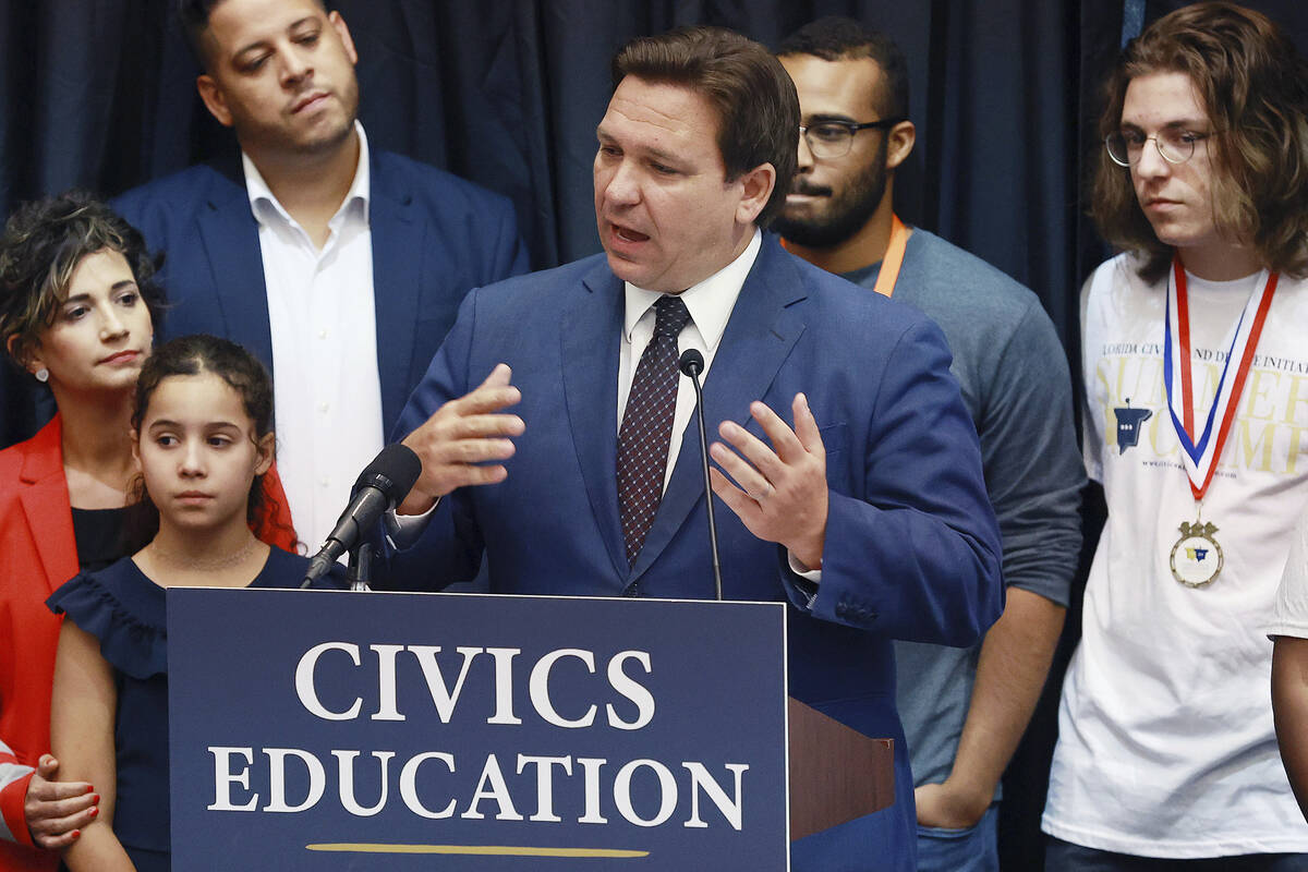 Florida governor Ron DeSantis speaks in front of students and teachers during a press conferenc ...