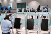 Clark County election workers set up voting booths at the Cora Coleman Senior Center in Las Veg ...