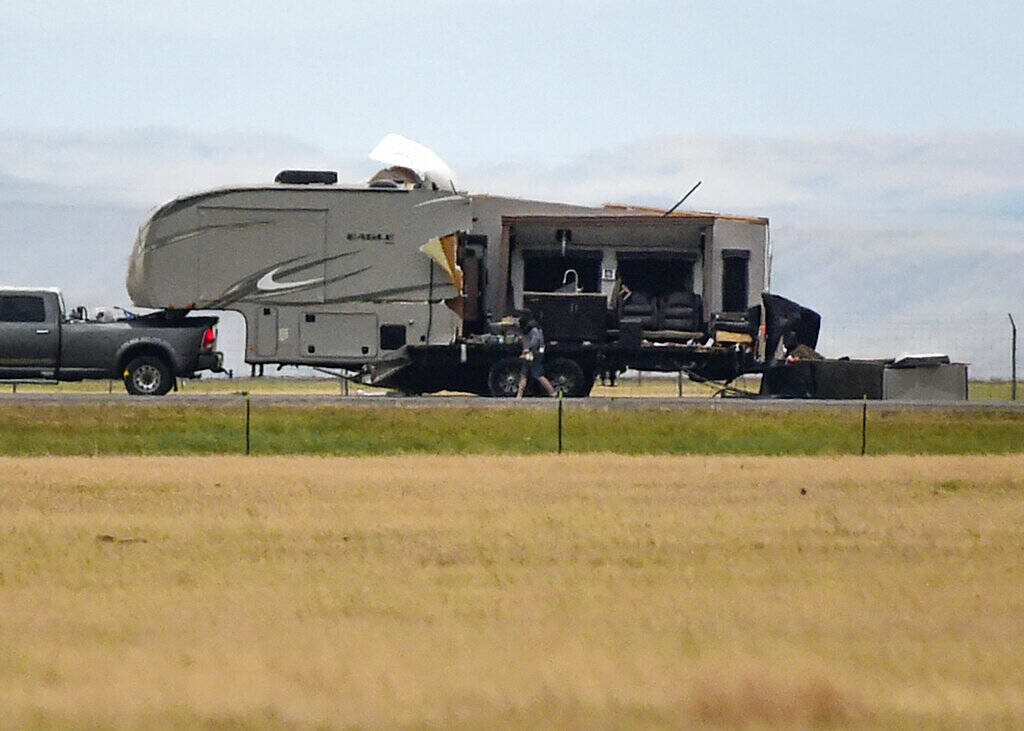 The side of a fifth wheel camper sits in pieces on Interstate 90 after a fatal pileup where at ...