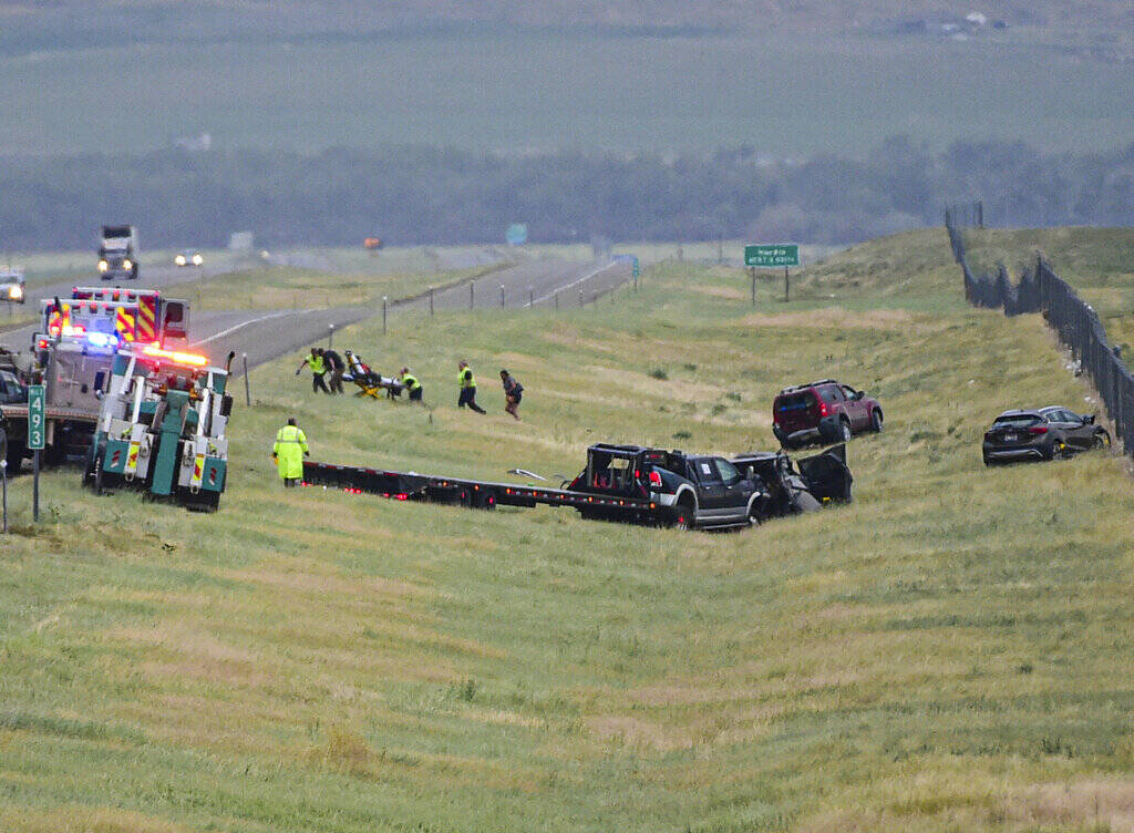 First responders work the scene on Interstate 90 after a fatal pileup where at least 20 vehicle ...