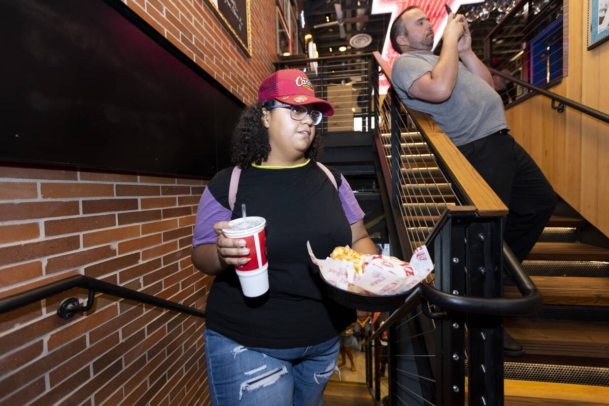 Kaylee Reese of Las Vegas dines-in during the grand opening of the Raising Cane’s restau ...