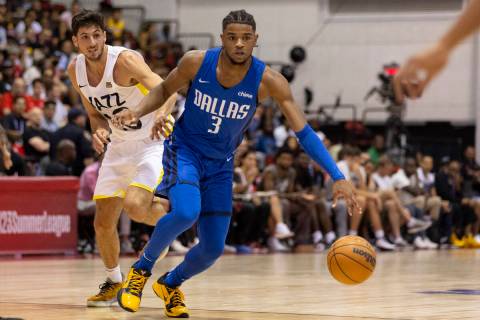 Dallas Mavericks Jaden Hardy (3) dribbles past Utah Jazz Leandro Bolmaro (10) during the first ...