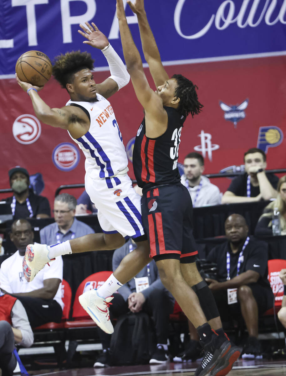 New York Knicks' Miles McBride (2) passes the ball around Portland Trail Blazers' George King d ...
