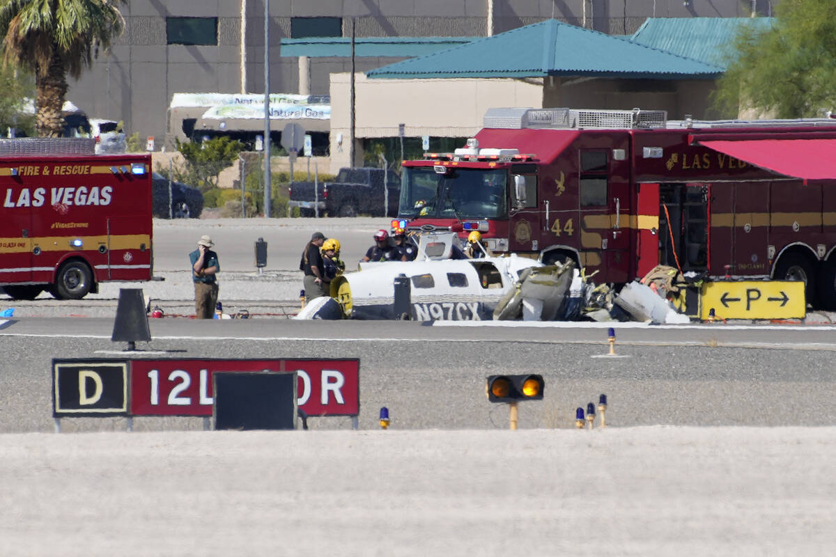 Officials investigate the wreckage of a plane at the site of a fatal crash at the North Las Veg ...