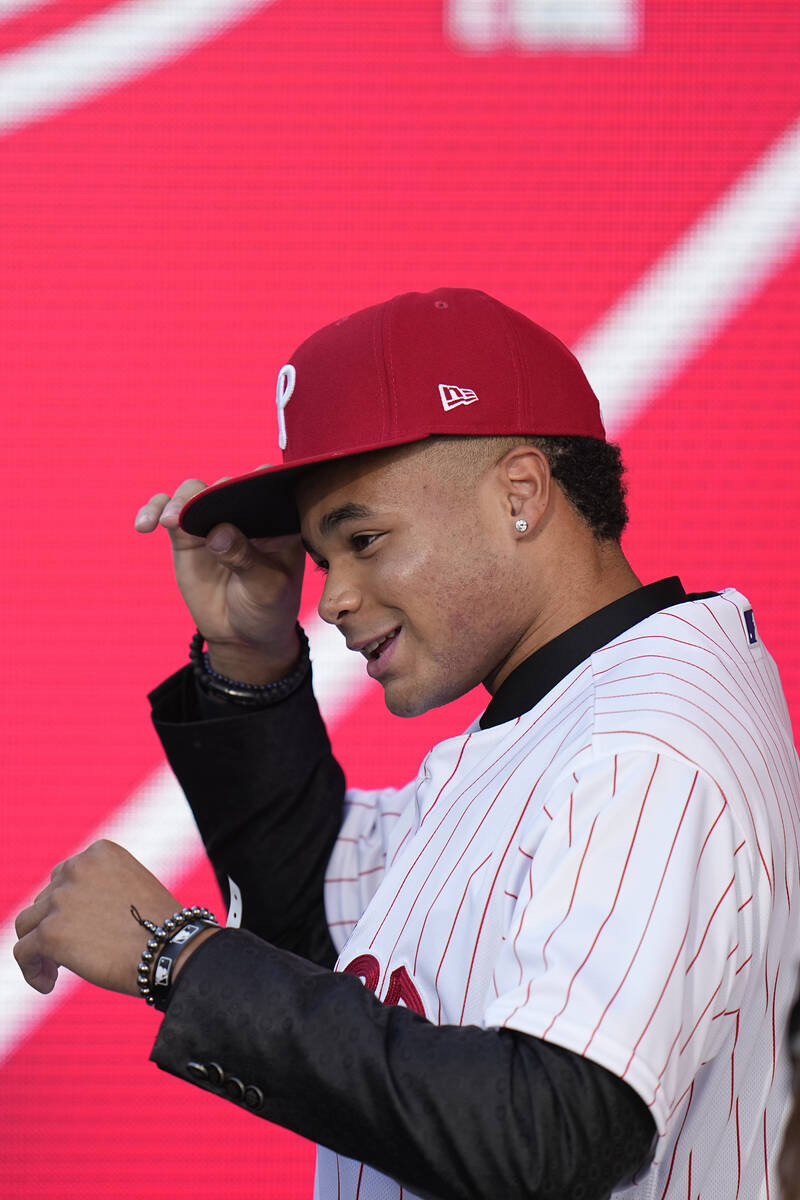 Justin Crawford adjusts his hat after being selected by the Philadelphia Phillies with the 17th ...